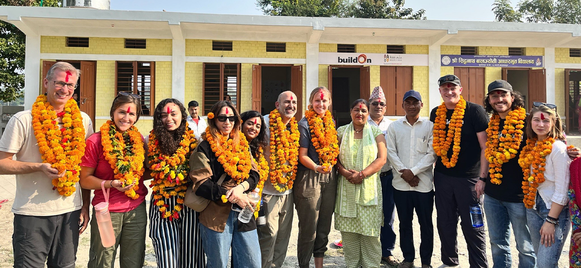 the group of volunteers standing in front of the school